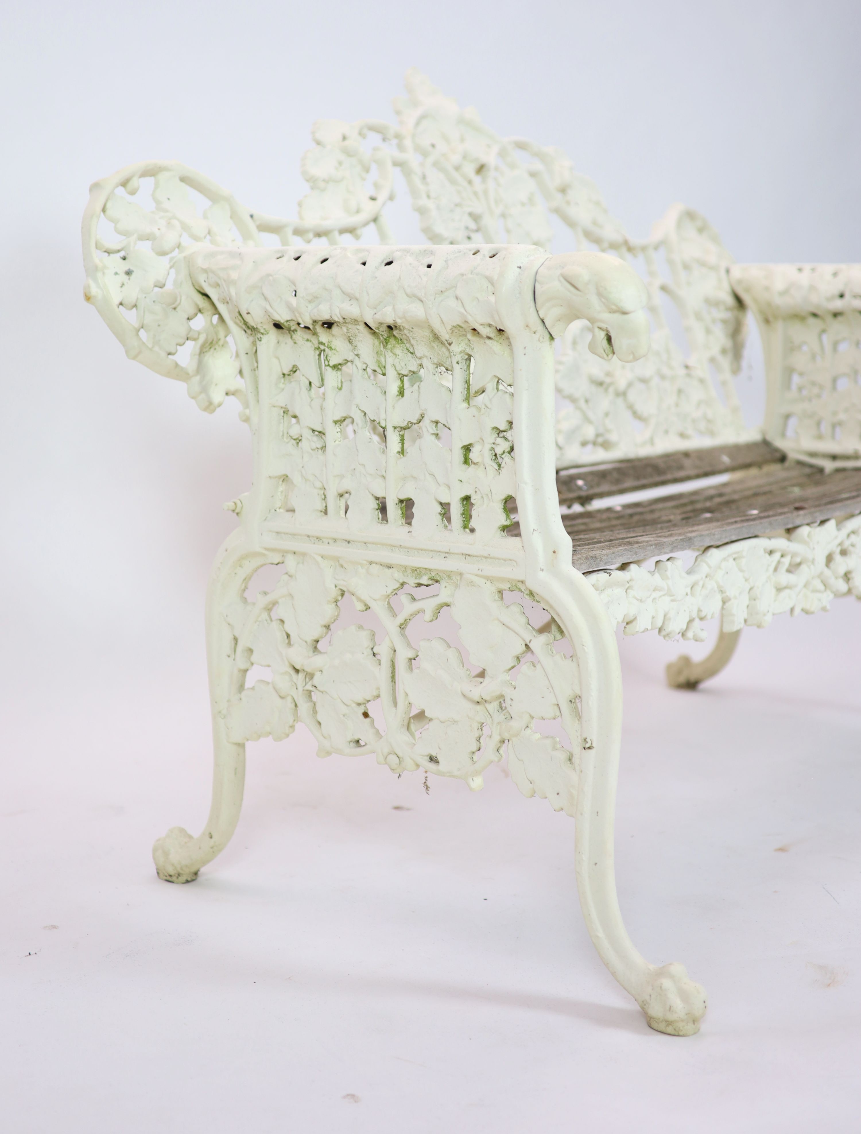 After Coalbrookdale, a pair of cast iron ‘Oak and ivy' benches H 95cm. W 148cm. D 68cm.